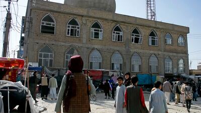 A Taliban fighter stands guard at the site of a bomb explosion inside a mosque in Mazar-e-Sharif province, Afghanistan, on April 21. AP