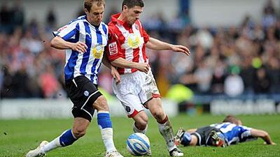 Sheffield Wednesday, in blue, could be playing city rivals United in the third tier of English football next season, a far cry from when the two clubs tussled in the Premier League. Anna Gowthorpe / PA