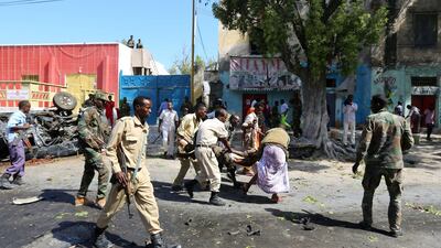 Rescuers carry a man who was injured in an attack on a restaurant by Somali Islamist group al Shabaab in the capital Mogadishu, Somalia, October 1, 2016. REUTERS