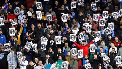 Malaga supporters protest while holding pictures of club owner Abdullah bin Nasser Al Thani. EPA