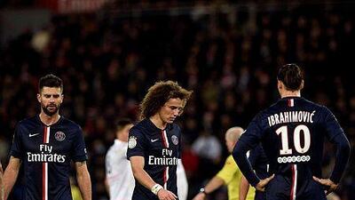 Paris Saint-Germain midfielder Thiago Motta, left, defender David Luiz and forward Zlatan Ibrahimovic react during their French Ligue 1 football match against Montpellier on December 20, 2014 at the Parc des Princes Stadium in Paris. AFP PHOTO / FRANCK FIFE