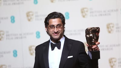 Asif Kapadia poses for photographers with his award for Best Documentary for Amy backstage. Joel Ryan / Invision / AP