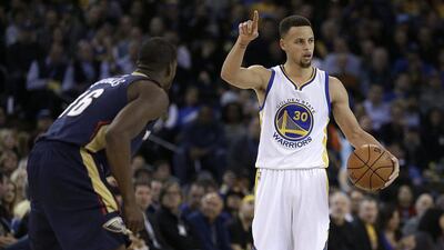 Golden State Warriors' Stephen Curry, right, gestures beside New Orleans Pelicans' Toney Douglas during the second half of an NBA basketball game Monday, March 14, 2016, in Oakland, Calif. (AP Photo/Ben Margot)