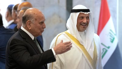 Iraqi Foreign Minister Fuad Hussein, left, welcomes Kuwaiti Foreign Minister Sheikh Salem Al Sabah in Baghdad on Sunday. AP