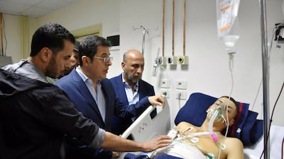 Syrian Health Minister Hassan Al Ghabash, second left, visiting the wounded in hospital. EPA