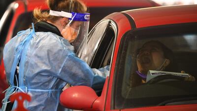 A member of a healthcare team works at a drive-through COVID-19 testing center at Chadstone Shopping Centre in Melbourne, Australia. EPA