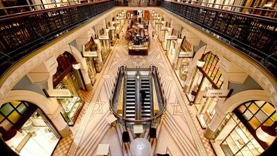 People walk through an empty shopping mall in the central business district of Sydney as people begin to stay at home due to fears over the coronavirus. AFP