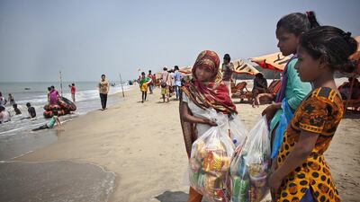 10 year old Jahanara, 12 year old Shuma, and 10 year old Aisha sell items on the beach. Like the girls, Alam dropped out of school and started working on the beach to help support his family at a young age. He started surfing when he was 16. He says that his way of giving back is by ensuring that girls get a good future through surfing.