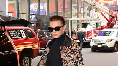 Millie Bobby Brown, wearing shorts and a jacket by Giambattista Valli, arrives at 'TRL' on November 1, 2017 in New York City. Photo: GC Images