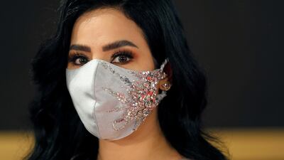 Saudi Arabian television personality Lojain Omran poses while wearing a face mask during the opening ceremony of the 42nd Cairo International Film Festival. Reuters