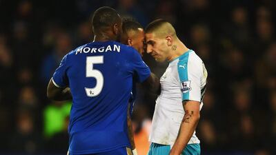 Aleksandar Mitrovic of Newcastle United and Danny Simpson of Leicester City clash as Wes Morgan of Leicester City (5) intervenes during the Premier League match between Leicester City and Newcastle United at The King Power Stadium on March 14, 2016 in Leicester, England. (Photo by Laurence Griffiths/Getty Images)