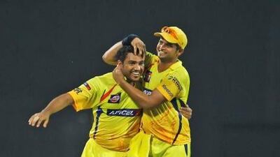 File picture of Suresh Raina, right, celebrating after top-scoring for Chennai Super Kings. Aijaz Rahi / AP Photo