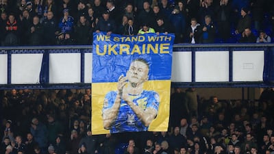 Everton fans hold a banner in the colours of the Ukraine national flag, and depicting Ukrainian defender Vitaliy Mykolenko. AFP