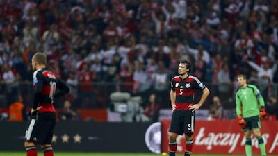 Mats Hummels, centre, Lukas Podolski, near, and Manuel Neuer, far, react during Germany's loss to Poland in Euro 2016 qualifying on Saturday night in Warsaw. Kacper Pempel / Reuters / October 11, 2014