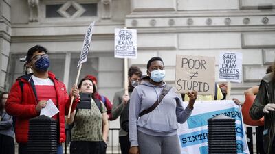 Students hold placards outside Downing Street in London as they protest against the downgrading of A-level results. AFP