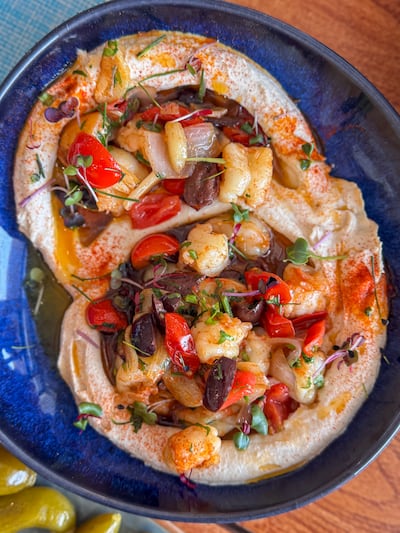 The hummus comes with sauteed prawns, cherry tomatoes, onions and olives. Photo: Ibn AlBahr