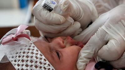 An UNRWA employee vaccinates a child in Bureij refugee camp, central Gaza, during a previous campaign. AFP
