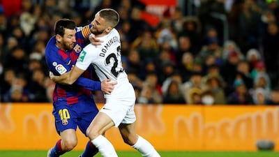 Barcelona's Lionel Messi (L) in action against Granada's Domijngos. EPA