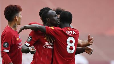 Sadio Mane celebrates with teammate Naby Keita after scoring his team's first goal against Aston Villa at Anfield on Sunday, July 5, 2020. EPA