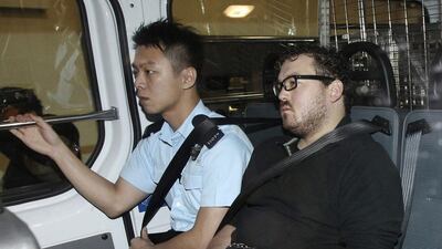 Rurik Jutting, right, a 29-year-old British banker, has been charged with two counts of murder. He is seen here inside a police van as it arrived at a court in Hong Kong on November 3, 2014. Apple Daily/Reuters