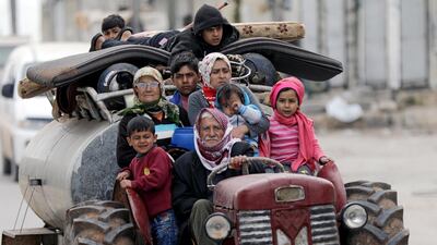 People flee after Turkish-backed Free Syrian Army fighters captured Khaldieh village in eastern Afrin, Syria on March 10, 2018. Khalil Ashawi / Reuters