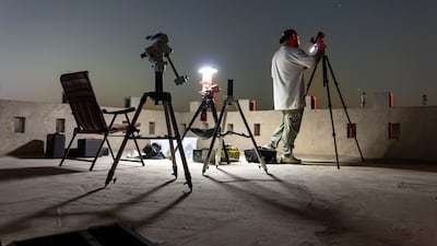 An astrophotographer, Faisal Jawad Alameeri, sets up his cameras. Antonie Robertson/The National