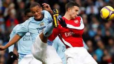 Vincent Kompany, left, clears from Arsenal's Robin van Persie in City's 3-0 win last Saturday.