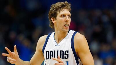 Dirk Nowitzki of the Dallas Mavericks reacts after sinking a three-point shot against the Sacramento Kings at American Airlines Centre on November 11, 2014, in Dallas, Texas. Tom Pennington / AFP