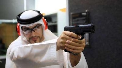 Ali humaid Al Nuaimi, shooter practicing his shooting skilss with a pistol at Caracal shoot club at Armed Forces Officers club in Abu Dhabi.