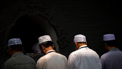 Chinese Hui Muslims pray in Beijing. A mosque built by the community in north-west China is under threat of demolition by authorities. AP Photo