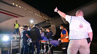 An injured Palestinian is helped onboard an Emirati aircraft at Al Arish, Egypt, for treatment in the UAE. Some Emiratis have been so moved by the suffering in Gaza to temporarily leave their careers and family behind to be of service of Palestinian civilians. AFP
