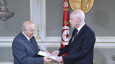 Sadok Belaid, left, the head of Tunisia’s constitution committee, submitting a draft of the new constitution to President Kais Saied, at Carthage Palace in Tunis. AFP