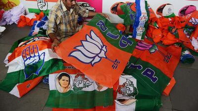 A worker folds and separates campaign flags for different political parties at a workshop in Hyderabad. Politicians are expected to spend as much as US$5 billion on campaigning for the multi-stage general election that begins on April 7. Noah Seelam /AFP / March 7, 2014