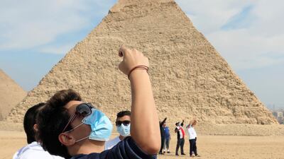 Tourists are seen in front of the pyramid of Khafre or "Chefren" in Giza, Egypt. Reuters