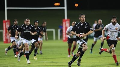 UAE rugby player Mark Weissenborn runs with the ball during Wednesday's Test match against Singapore. Sarah Dea / The National / April 23, 2014