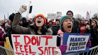 Demonstrators hold signs at the 2018 March for Our Lives rally in Chicago. AP