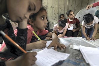 Children attend an Arabic language lesson given by a Palestinian school girl Fajr Hmaid, 13, in Gaza City. NurPhoto via Getty Images