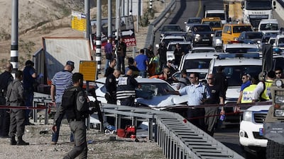 Israeli security forces stand at the site where a Palestinian man allegedly rammed his car into Israelis soldiers standing by a bus station next to the Jewish settlement of Kfar Adumim in the occupied West Bank on November 27, 2015. Ahmad Gharabli/AFP Photo