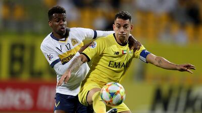 Abdulla Al Khabari, left, of Al Nassr vies for the ball against Caio Canedo of Al Wasl at Zabeel Stadium in Dubai. AFP