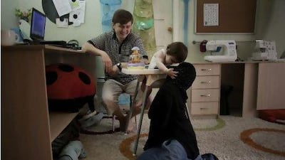 Rashid Abdurakhmanov and his wife Ayat in their apartment in Makhachkala, Dagestan, with one of their two children. They follow the Salafi form of Islam. "We don't want to impose our beliefs on anyone else," Mr Abdurakhmanov said. Photo for The Washington Post by Andrea Bruce