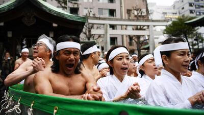 Shinto believers of the Teppozu Inari Shrine take a bath in cold water to purify their souls and bodies. AFP