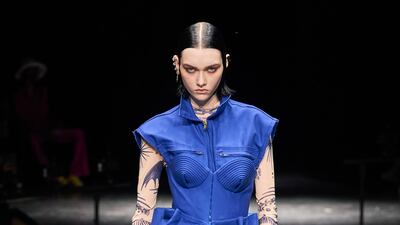 A utilitarian jumpsuit is elevated with a corseted dress at Jean Paul Gaultier.