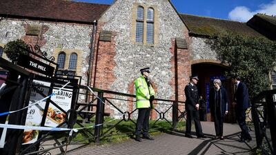 Britain's Prime Minister Theresa May stands outside The Mill pub, as she views the area where former Russian double agent Sergei Skripal and his daughter were found critically ill, in Salisbury, England, Thursday, March 15, 2018. May on Wednesday expelled 23 Russian diplomats, severed high-level contacts and vowed both open and covert action following the incident. (Toby Melville/Pool Photo via AP)