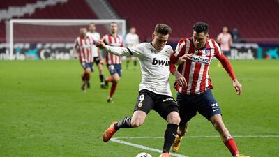 Valencia's French forward Kevin Gameiro vies with Atletico Madrid's Uruguayan defender Jose Gimenez. AFP