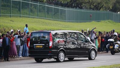 People cheer as the funeral cortege carrying the coffin of former South African President Nelson Mandela leaves the 1 Military Hospital on the outskirts of Pretoria today, on its way to the Union Buildings. Thomas Mukoya / Reuters
