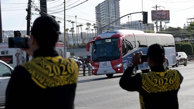 Members of Mexico's National Guard record with their mobile phones the arrival of the bus transporting Iran's national football team at the Caliente Stadium for a training session in Tijuana, Mexico. AFP