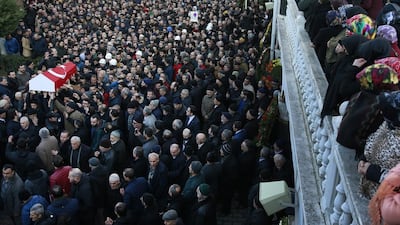 Mourners watch as others carry the Turkish flag-draped coffin of 23-year-old victim Yunus Gormek during his funeral in Istanbul on January 2, 2017. Emrah Gurel/AP Photo