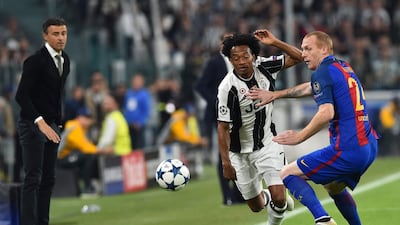 Barcelona manager Luis Enrique, far left, looks on as defender Jeremy Mathieu, right, vies with Juventus forward Juan Cuadrado. Giuseppe Cacace / AFP
