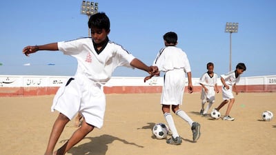 Youth in Karachi, Pakistan train at a local pitch as part of an academy funded by the Real Madrid Foundation. Asif Hassan / AFP