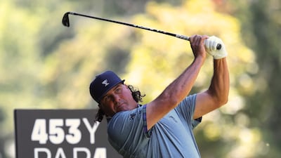 Pat Perez watches his tee shot on the fourth hole. AP